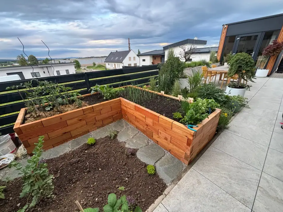 L-shaped Brick Premium raised bed with plants on a family-house terrace